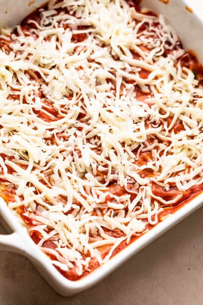 square baking dish with uncooked vegetable lasagna.