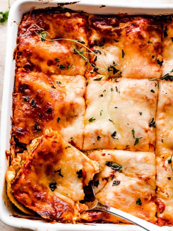 overhead shot of a square baking dish with vegetable lasagna cut in squares.