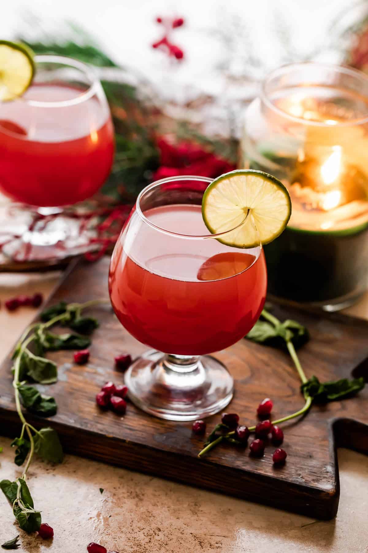 Yuletide Daisy Cocktails served in a cognac goblet with a slice of lime set on the rim.