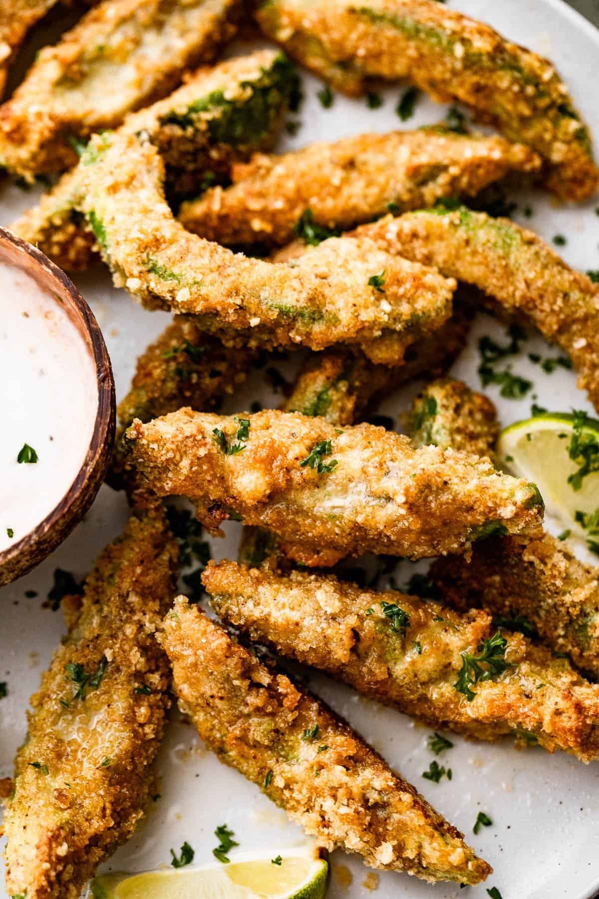 air fried avocado fries arranged on a plate.