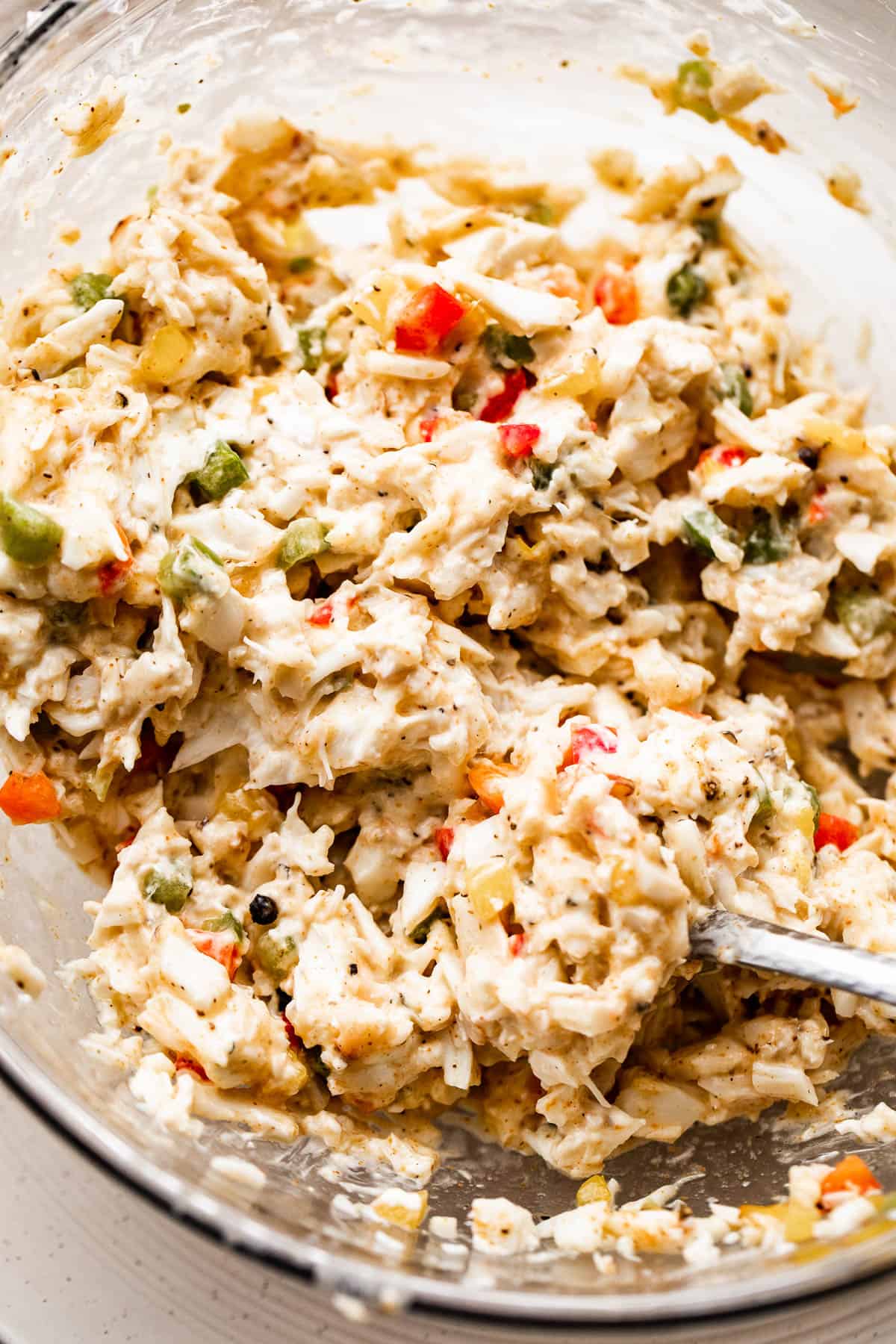 a mixture of crab meat in a glass mixing bowl.