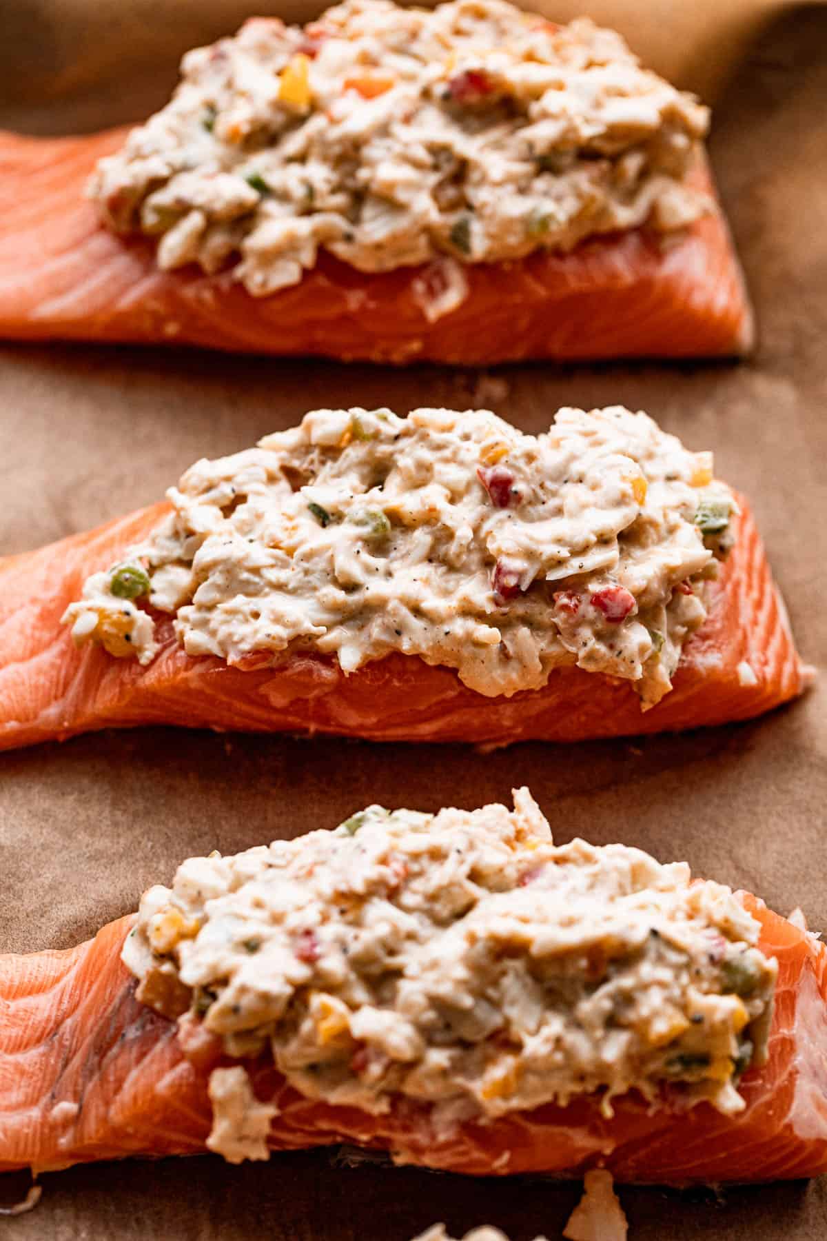 three raw salmon fillets stuffed with crab.