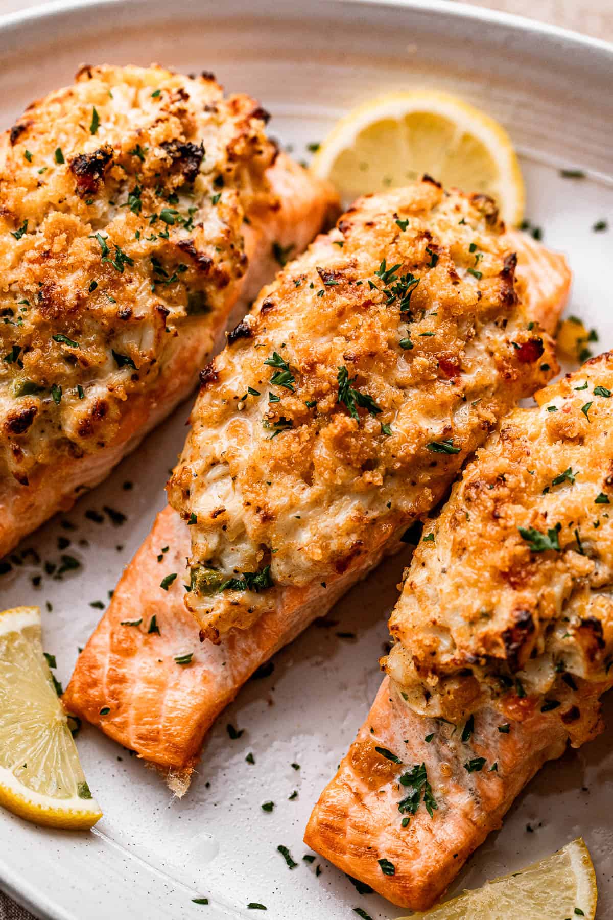 Overhead image of three stuffed salmon fillets served on a gray plate.