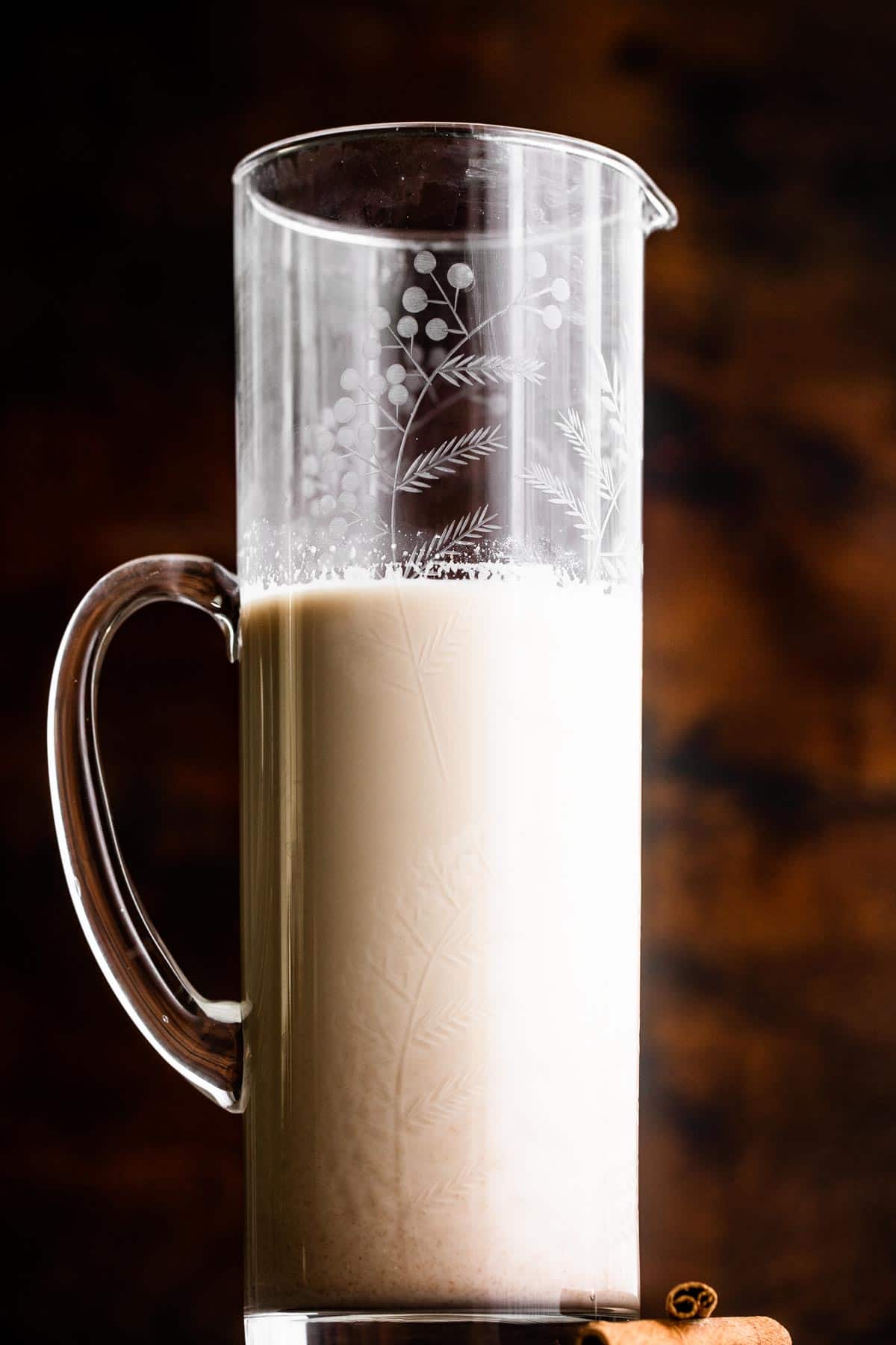 a tall glass pitcher filled with Horchata
