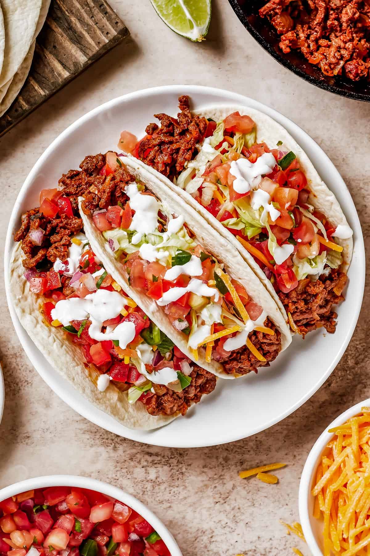 overhead shot of three Ground Beef Tacos served on a white plate.