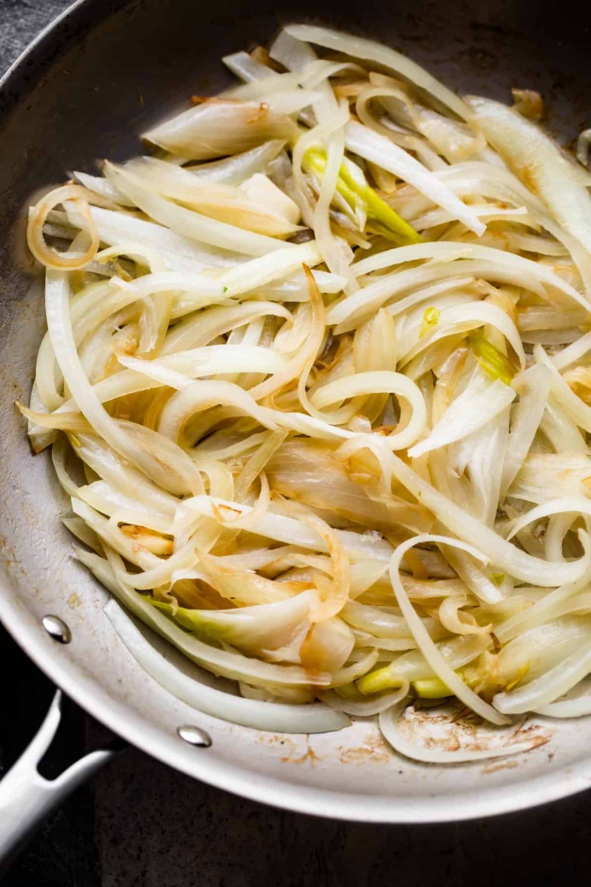 caramelizing onions in a skillet.