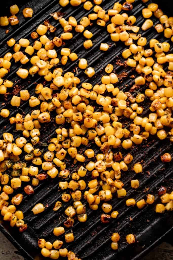 cooking corn kernels in a grill pan.
