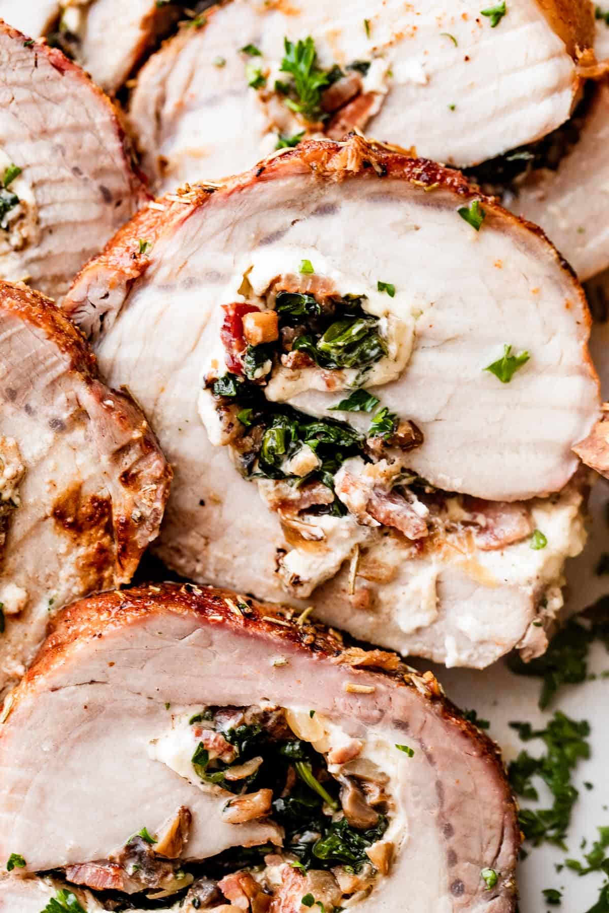 up close shot of stuffed pork loin cut into slices.