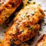 overhead close up shot of three air fryer chicken breasts.