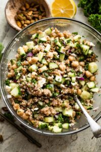 overhead shot of a glass mixing bowl with bulgur salad.