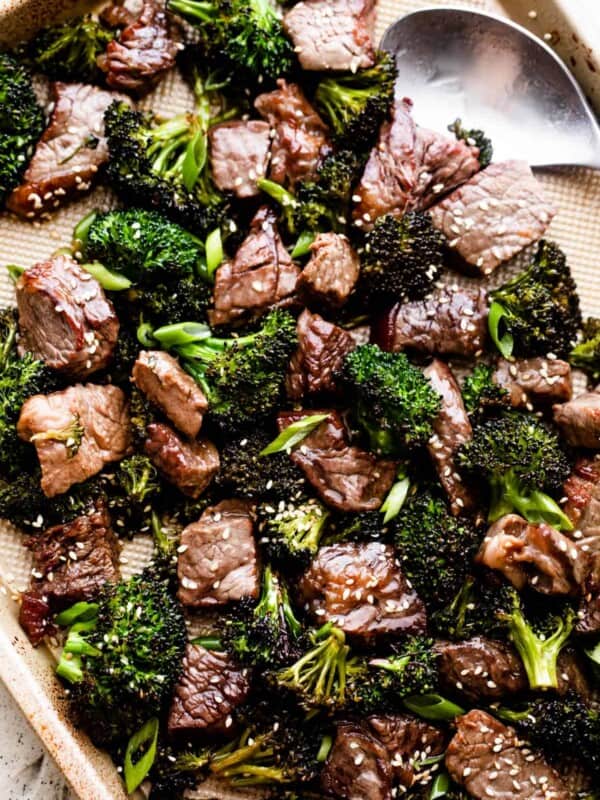 overhead shot of sesame beef and broccoli arranged on a baking sheet.