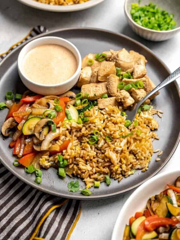 A plate with Hibachi chicken fried rice and veggies