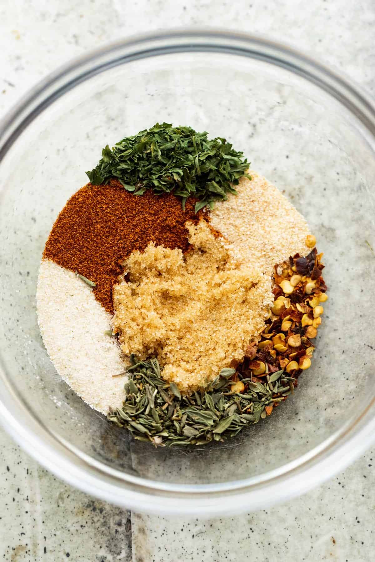 seasonings and herbs arranged in a small mixing bowl.