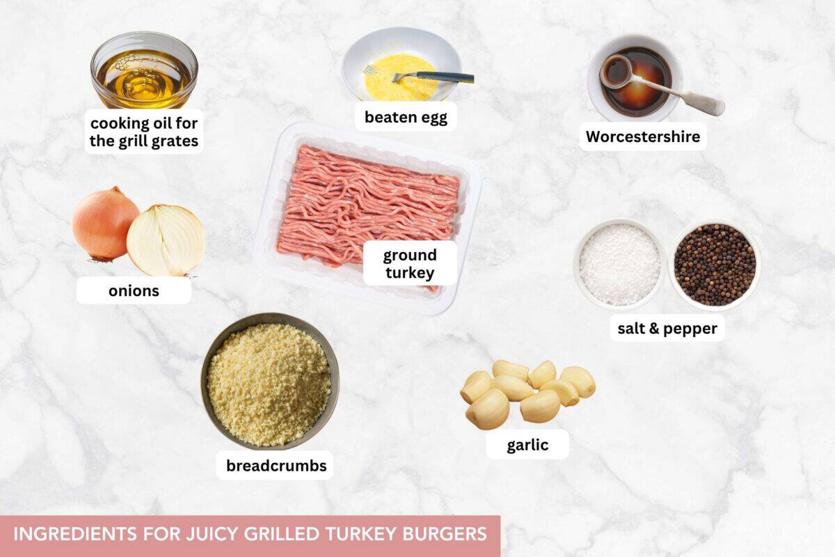 With just a few simple ingredients, these Juicy Grilled Turkey Burgers are guaranteed to turn out savory, tender, and perfect, every time! Ingredients for turkey burgers are arranged on a white surface.