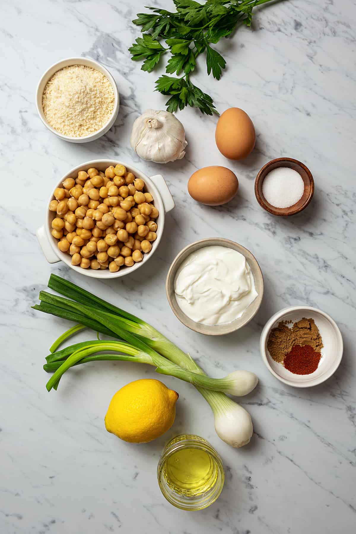 From top left: Breadcrumbs, parsley, garlic, eggs, salt, chickepeas, yogurt, seasonings green onions, lemons.