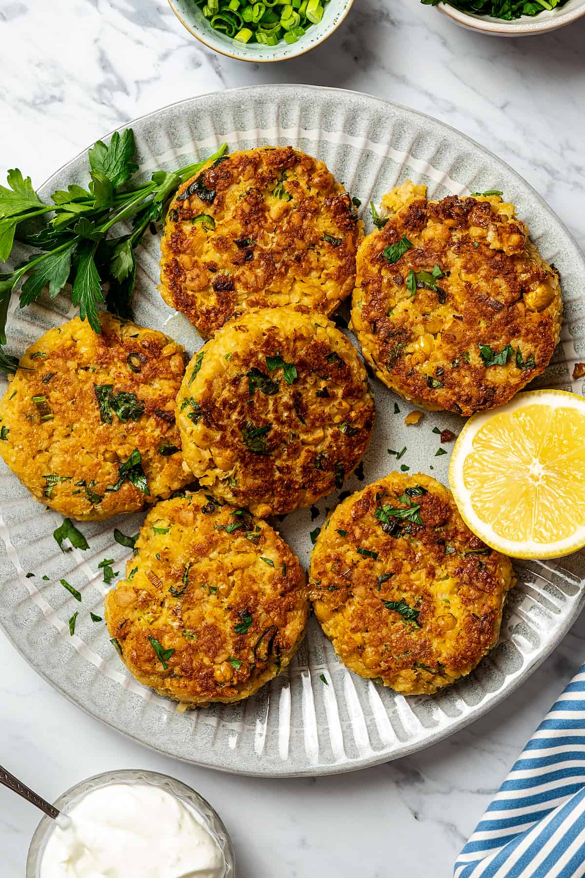 Vegetarian patties made of chickpeas, lightly fried and arranged on a serving plate.