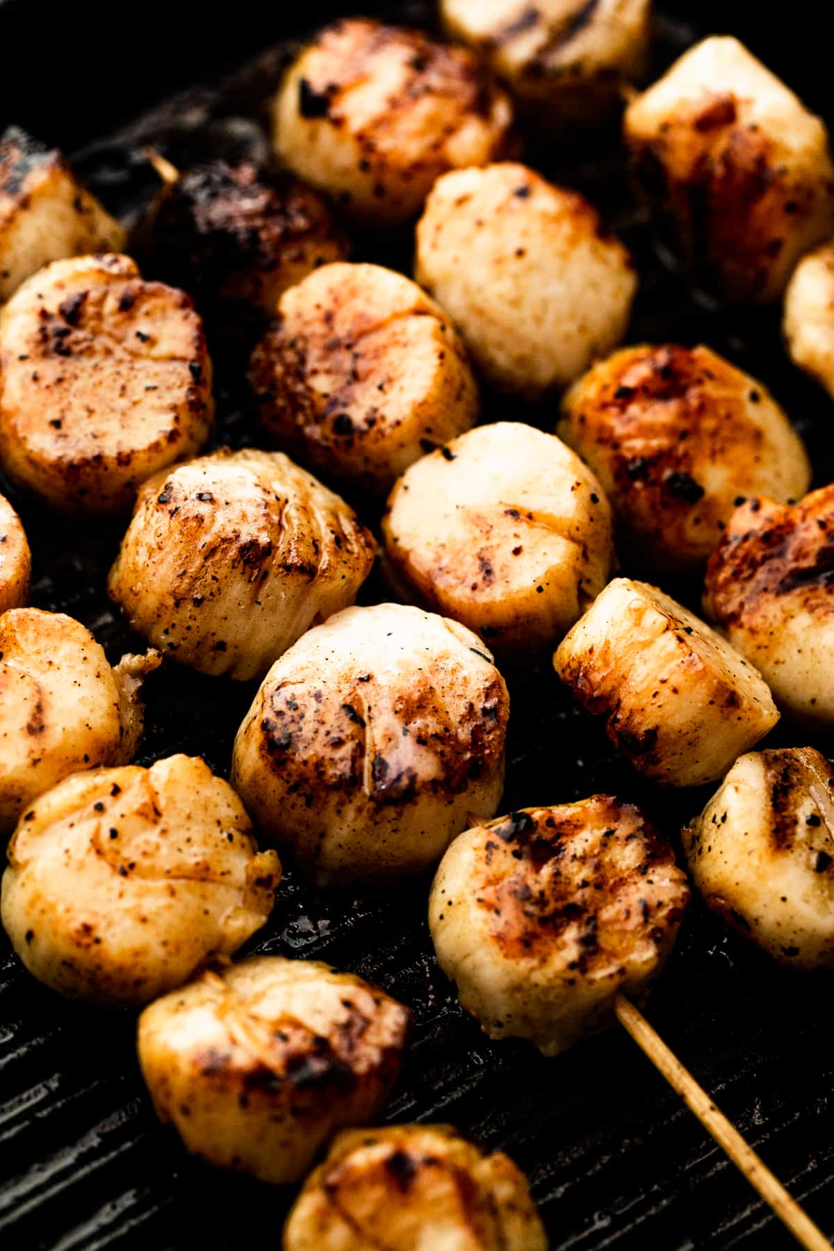 Cooking scallop skewers on the grill.