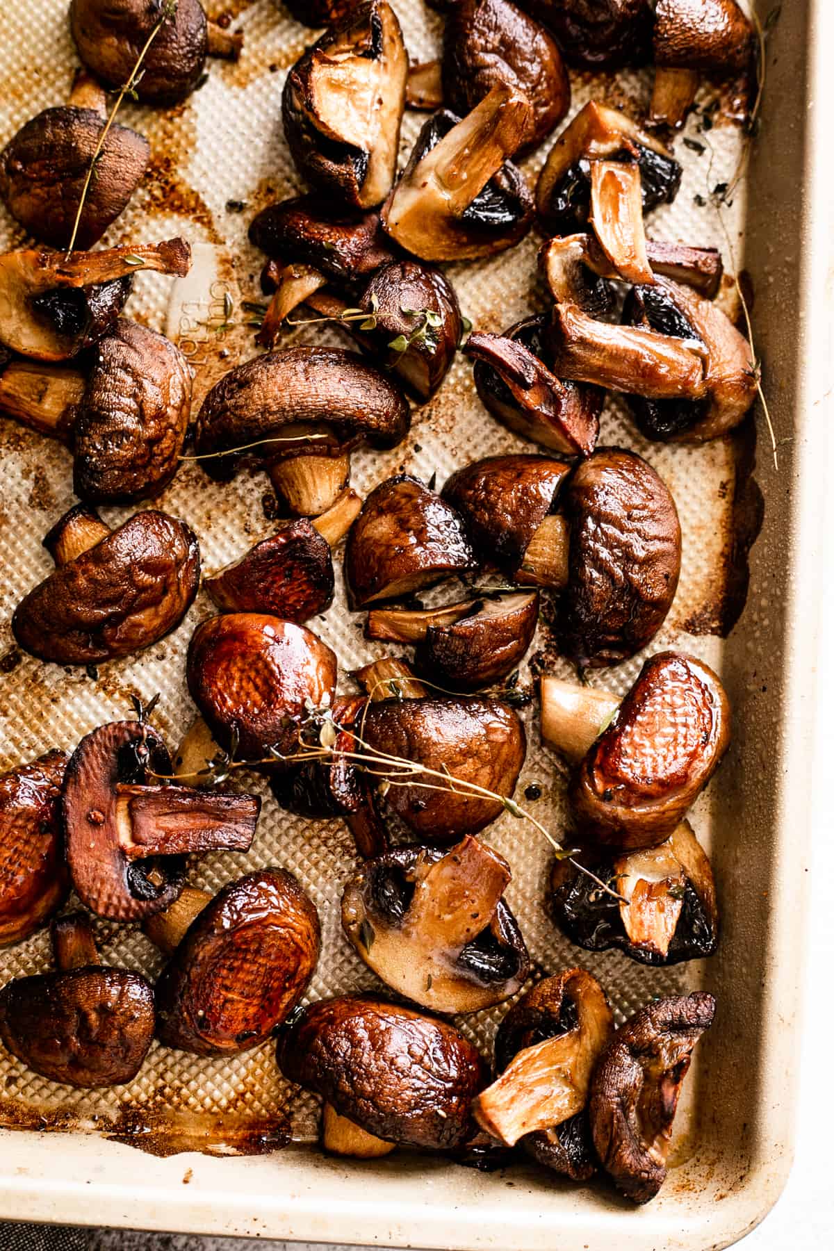 roasted halved mushrooms arranged on a baking sheet.