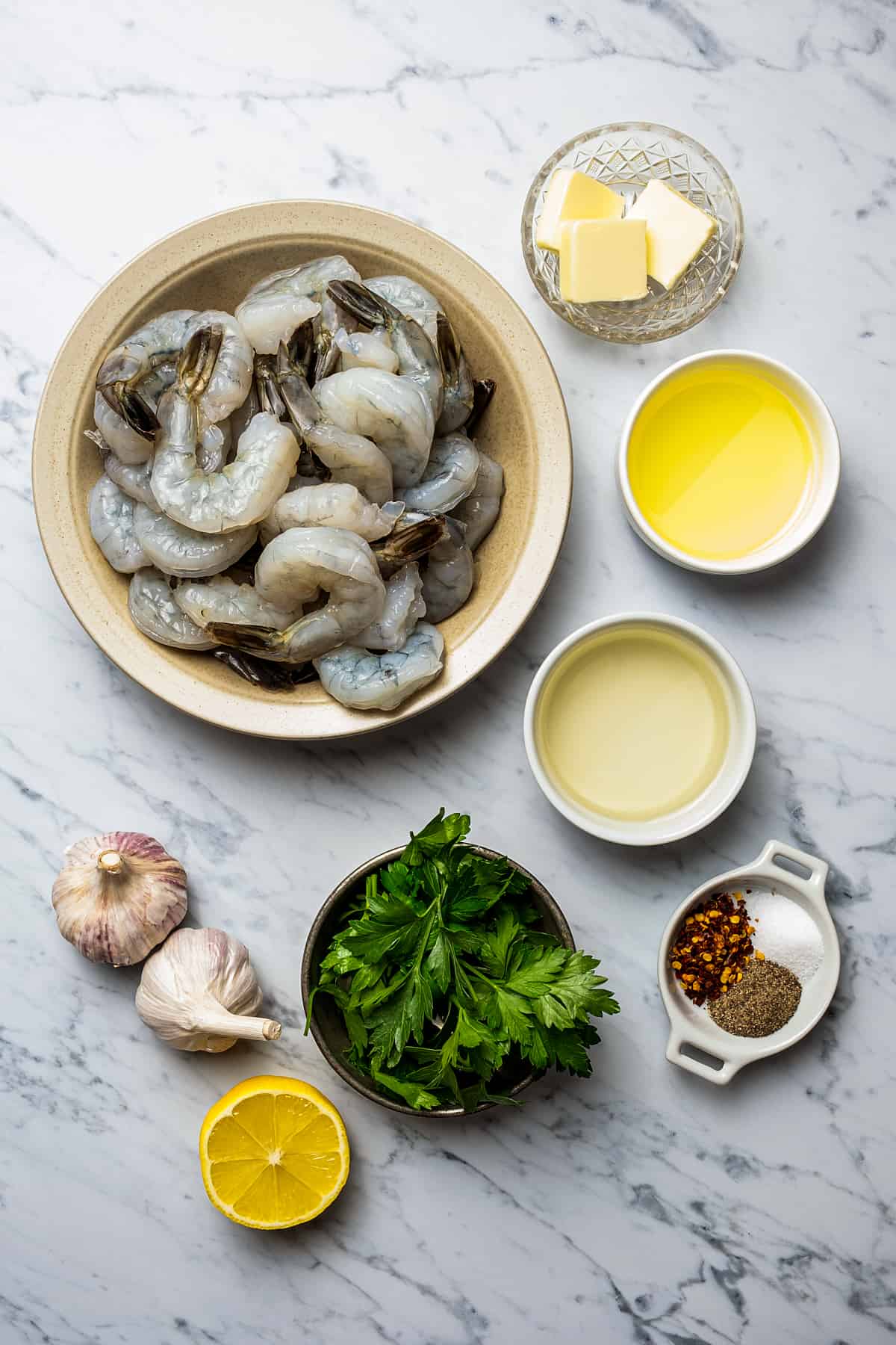 Ingredients for shrimp scampi in small bowls