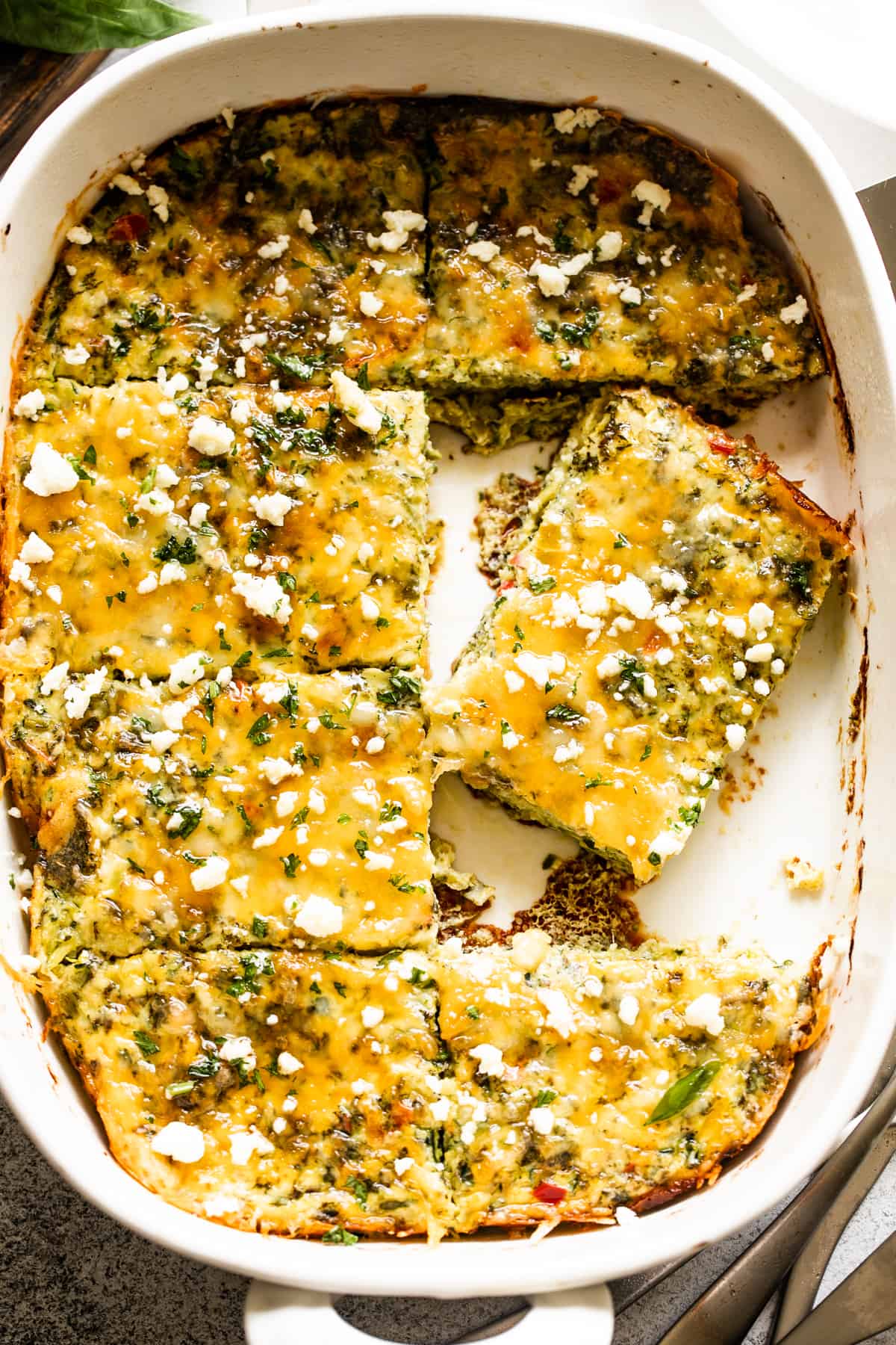 overhead shot of zucchini egg bake in a white baking dish.