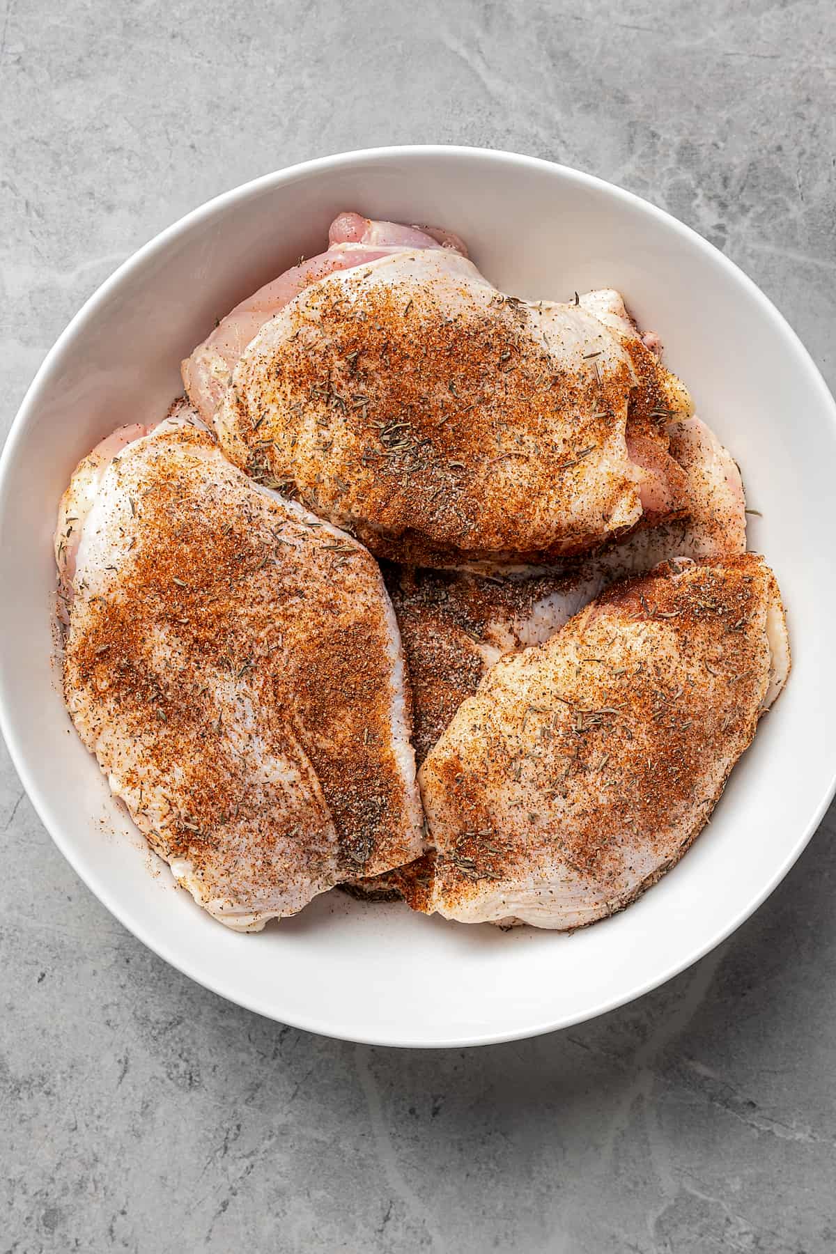 Seasoned chicken, ready to be cooked.