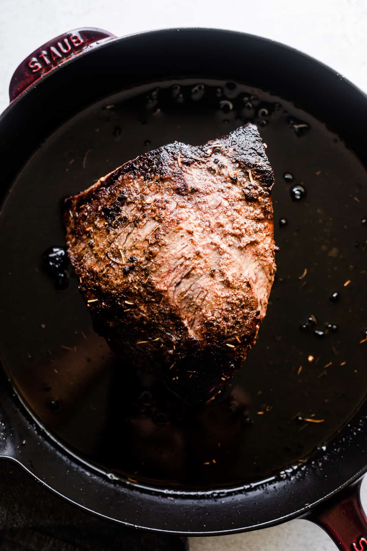 browning beef tri tip in a cast iron skillet.