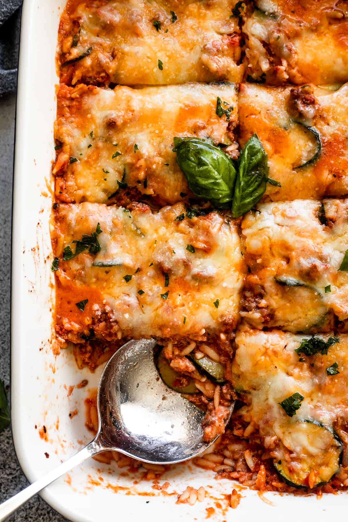 close up shot of Beef Zucchini Casserole in a baking dish.