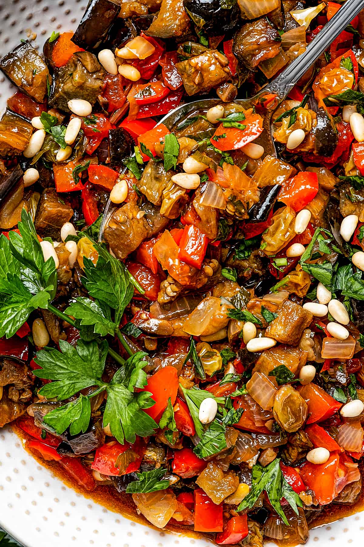 close up photo of caponata in a white bowl.