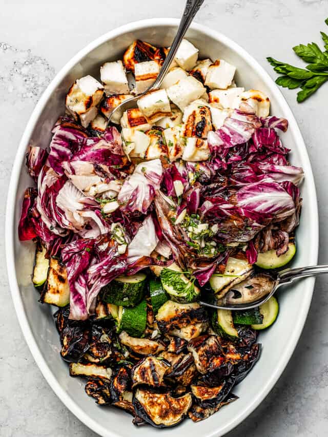 Grilled salad ingredients in an oval dish.