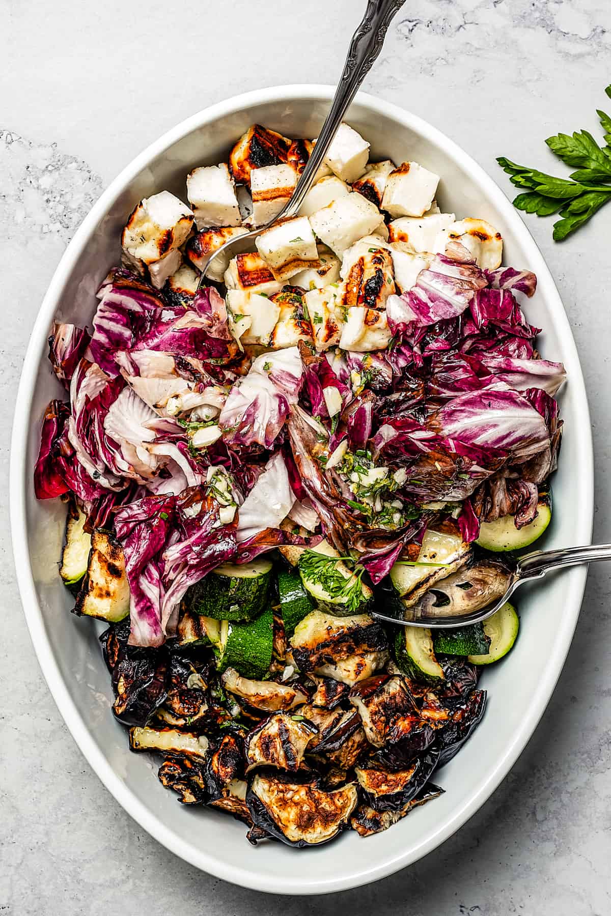 Grilled salad ingredients in an oval dish.