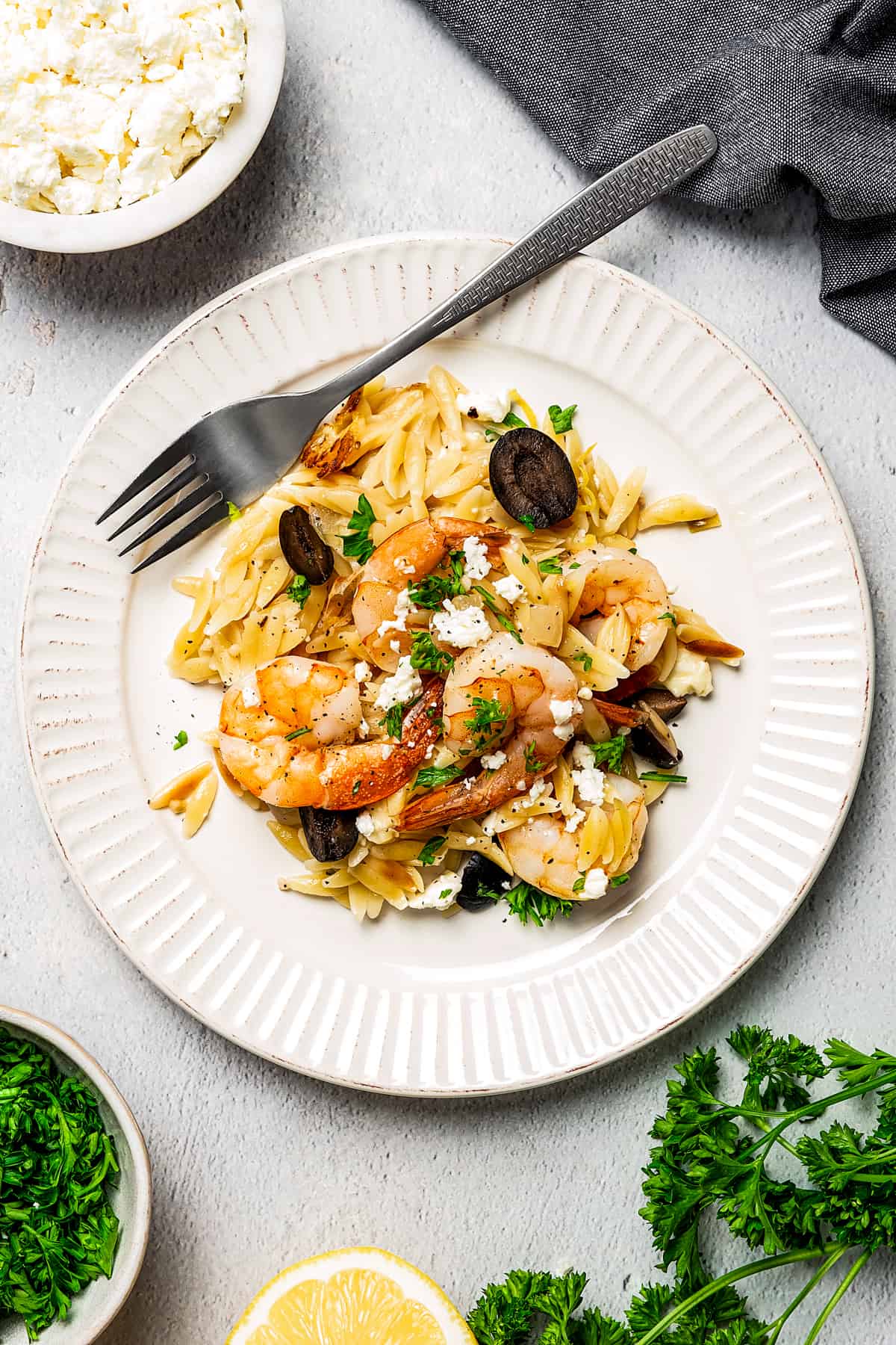 A serving of one-pot shrimp and orzo pasta with a fork.