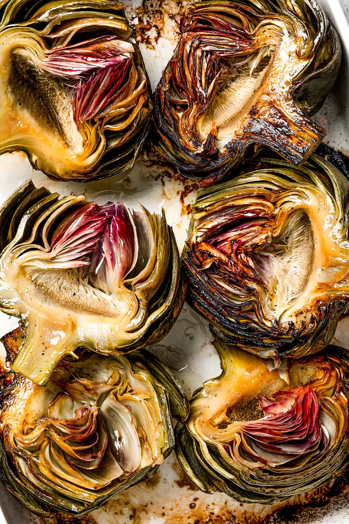 Artichokes that have been roasted and then turned cut-side up to show the texture.