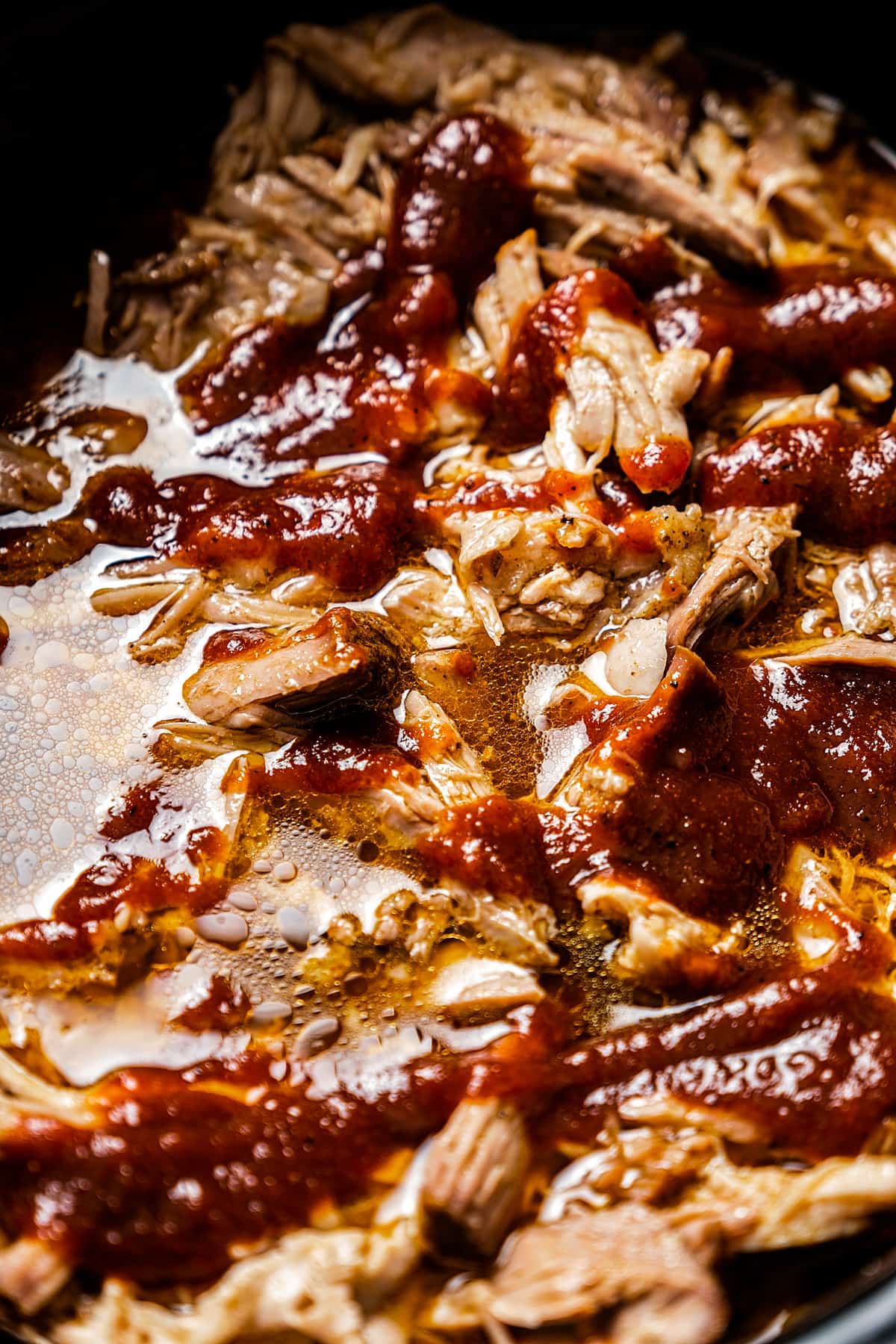 Close-up shot of slow cooker pulled pork in barbecue sauce.