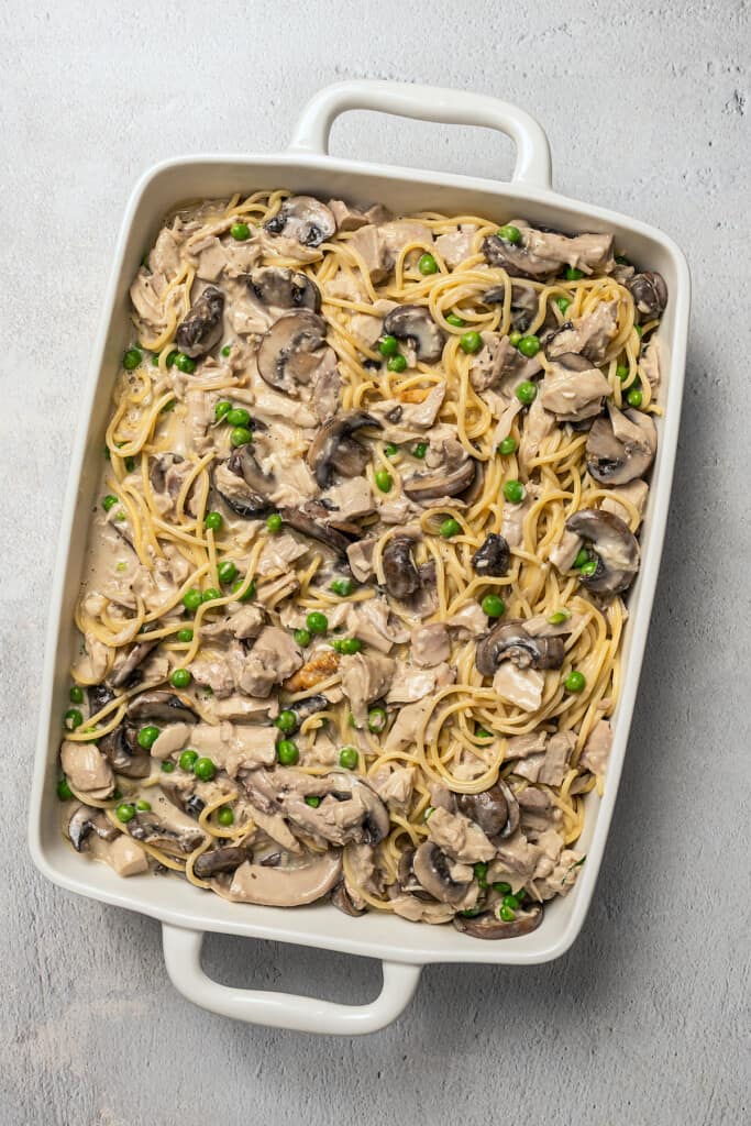 A casserole dish filled with pasta in creamy mushroom sauce.