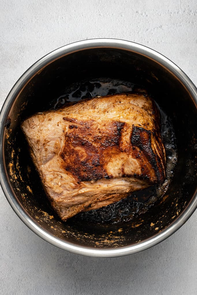 Pork shoulder browning in the Instant Pot.