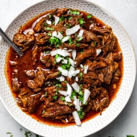 Mexican shredded beef in a white serving dish.