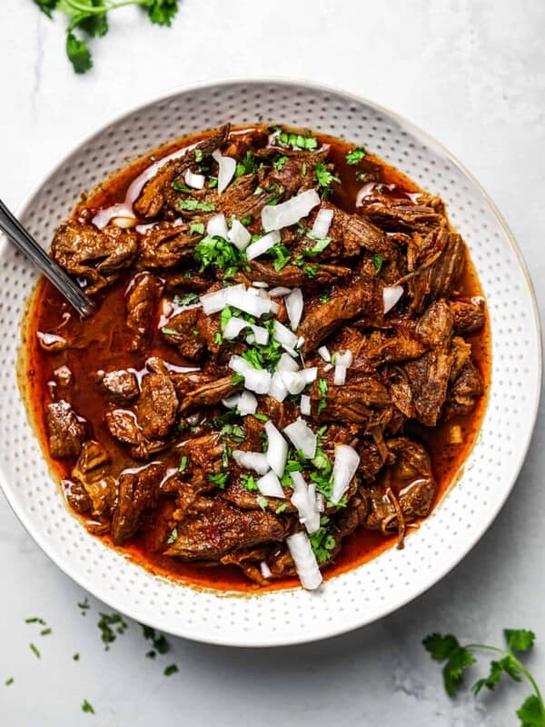 Mexican shredded beef in a white serving dish.
