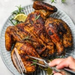 Carving a cooked whole chicken.