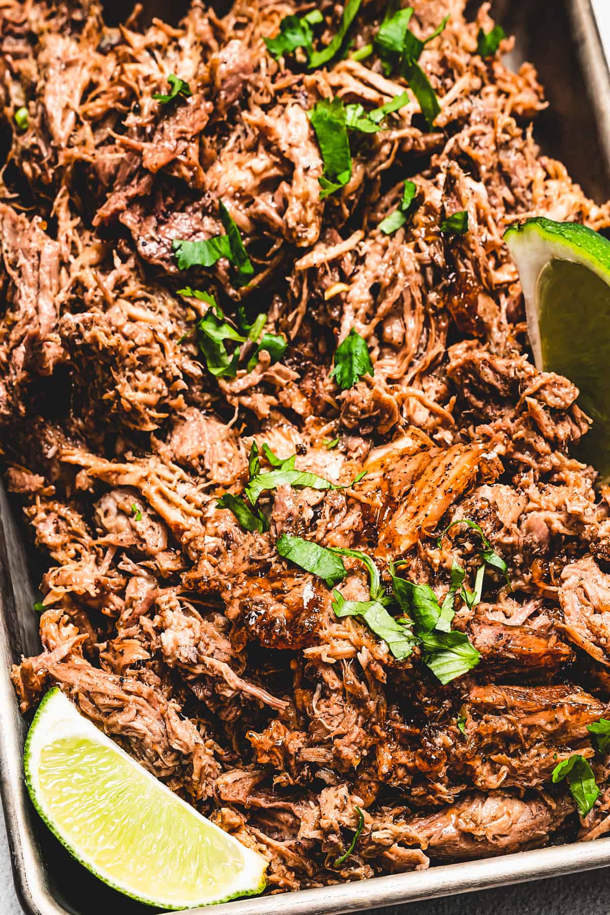 Puerto Rican pernil garnished with herbs.