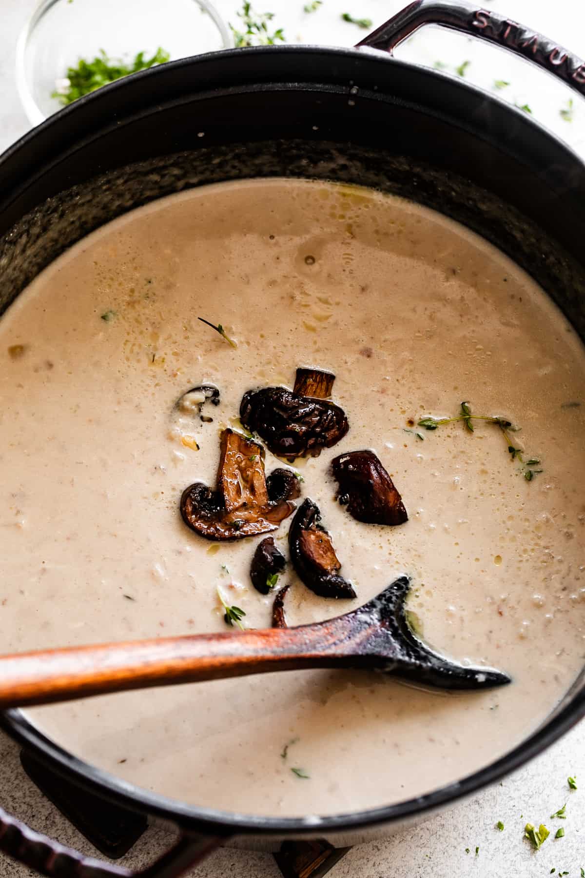 cooking mushroom soup in a dutch oven and stirring through with a wooden spoon