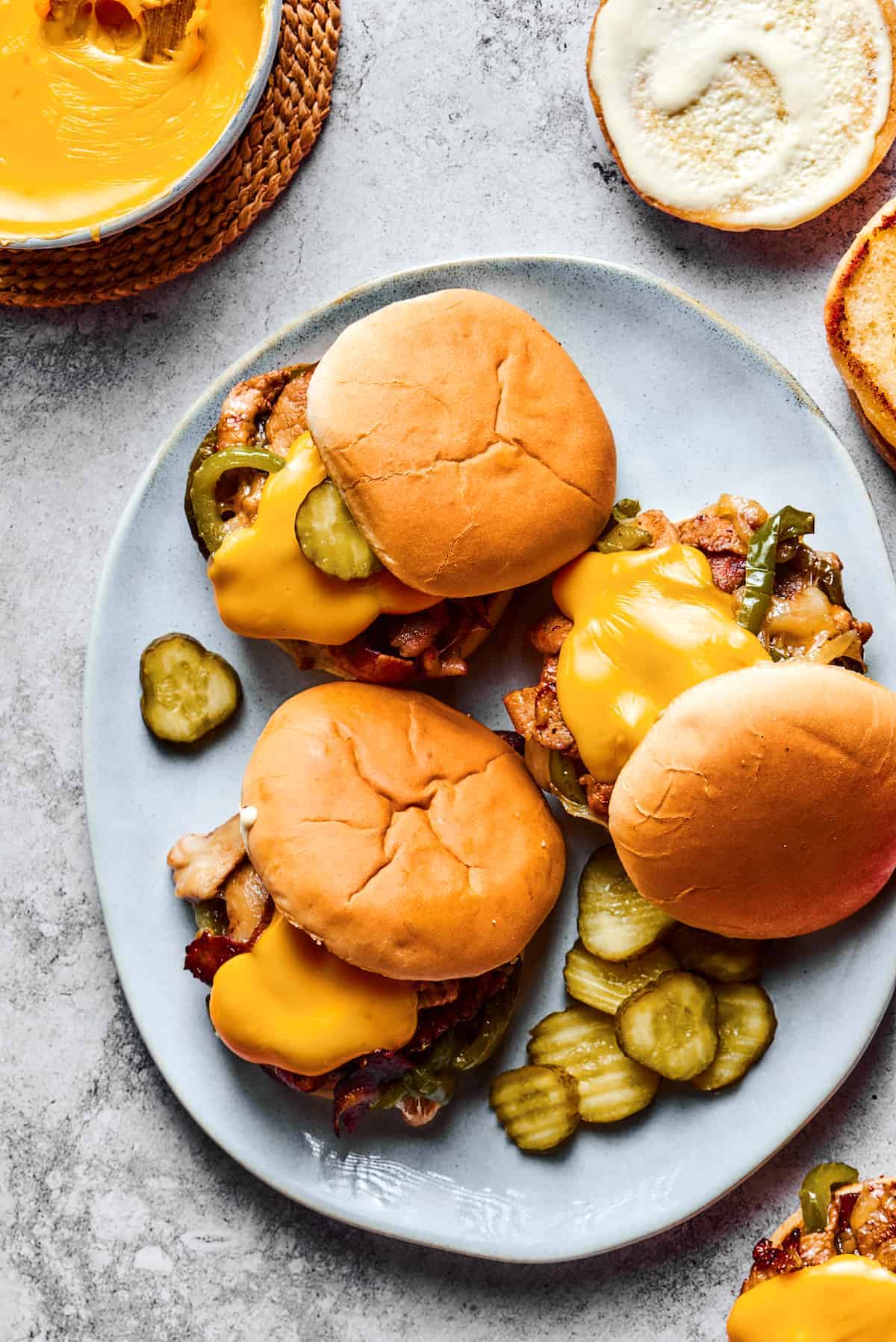 Philly Cheesesteak Burgers arranged on a plate.