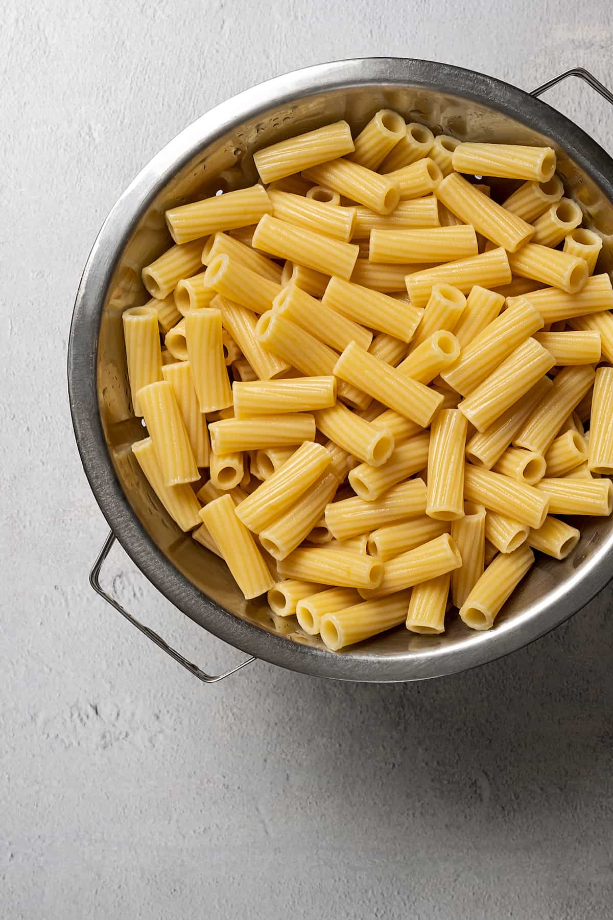 Rigatoni pasta draining in a colander.