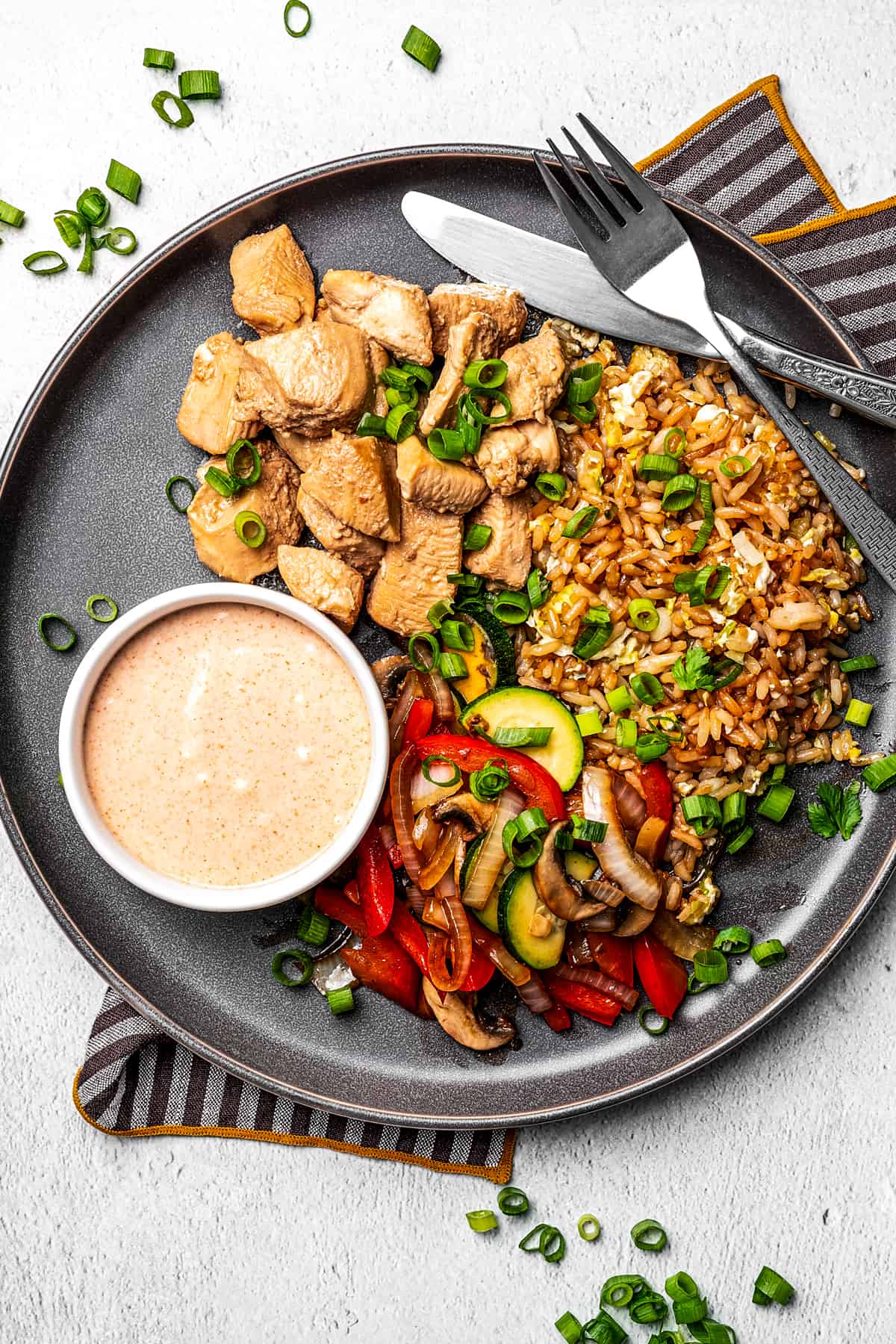 A plate with Hibachi chicken fried rice and veggies