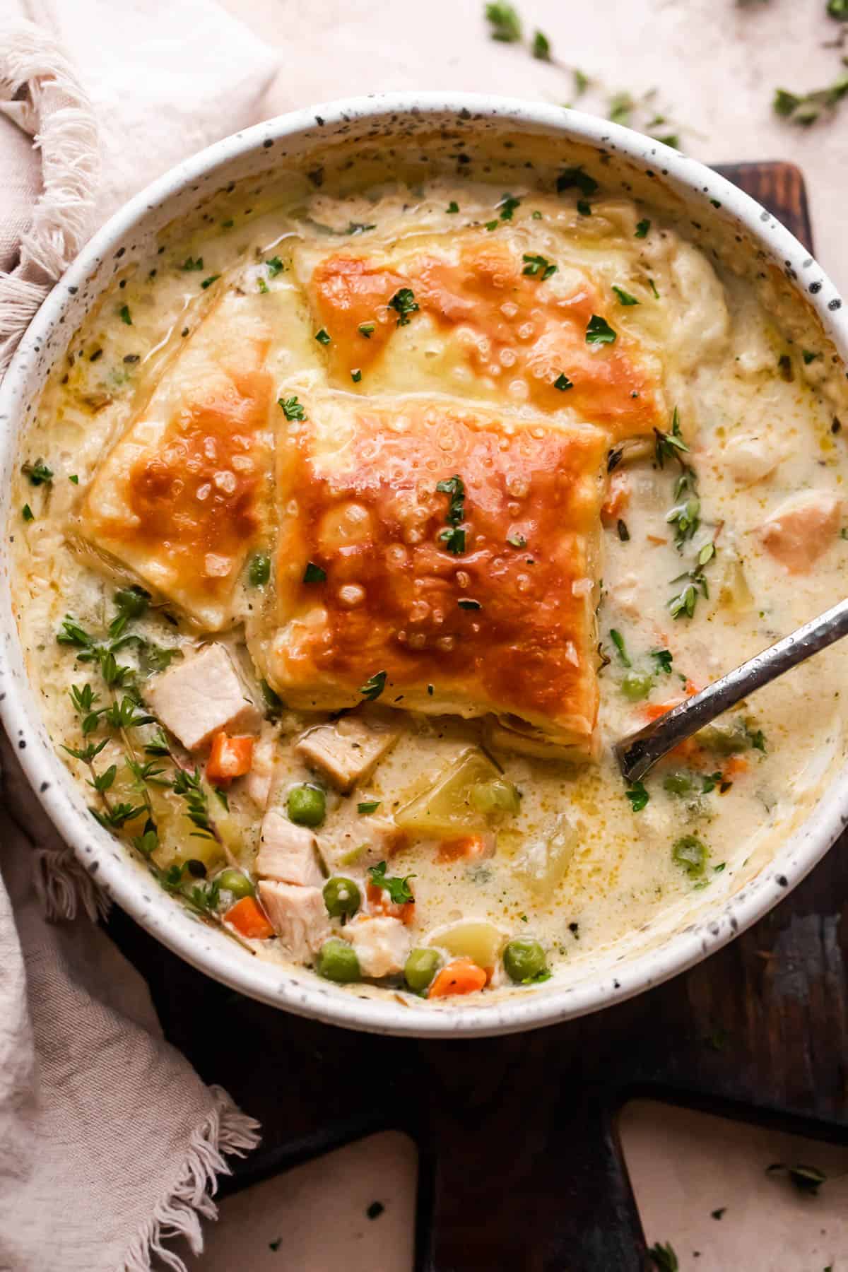 Leftover Turkey Pot Pie Soup Served in a soup bowl and topped with baked puff pastry squares