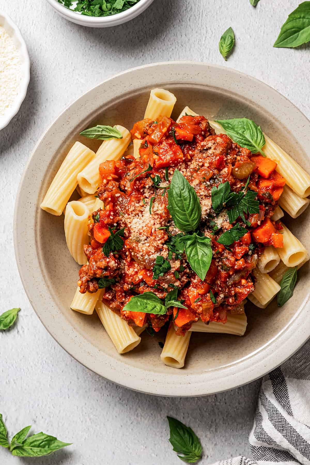 Pasta bolognese garnished with herbs.