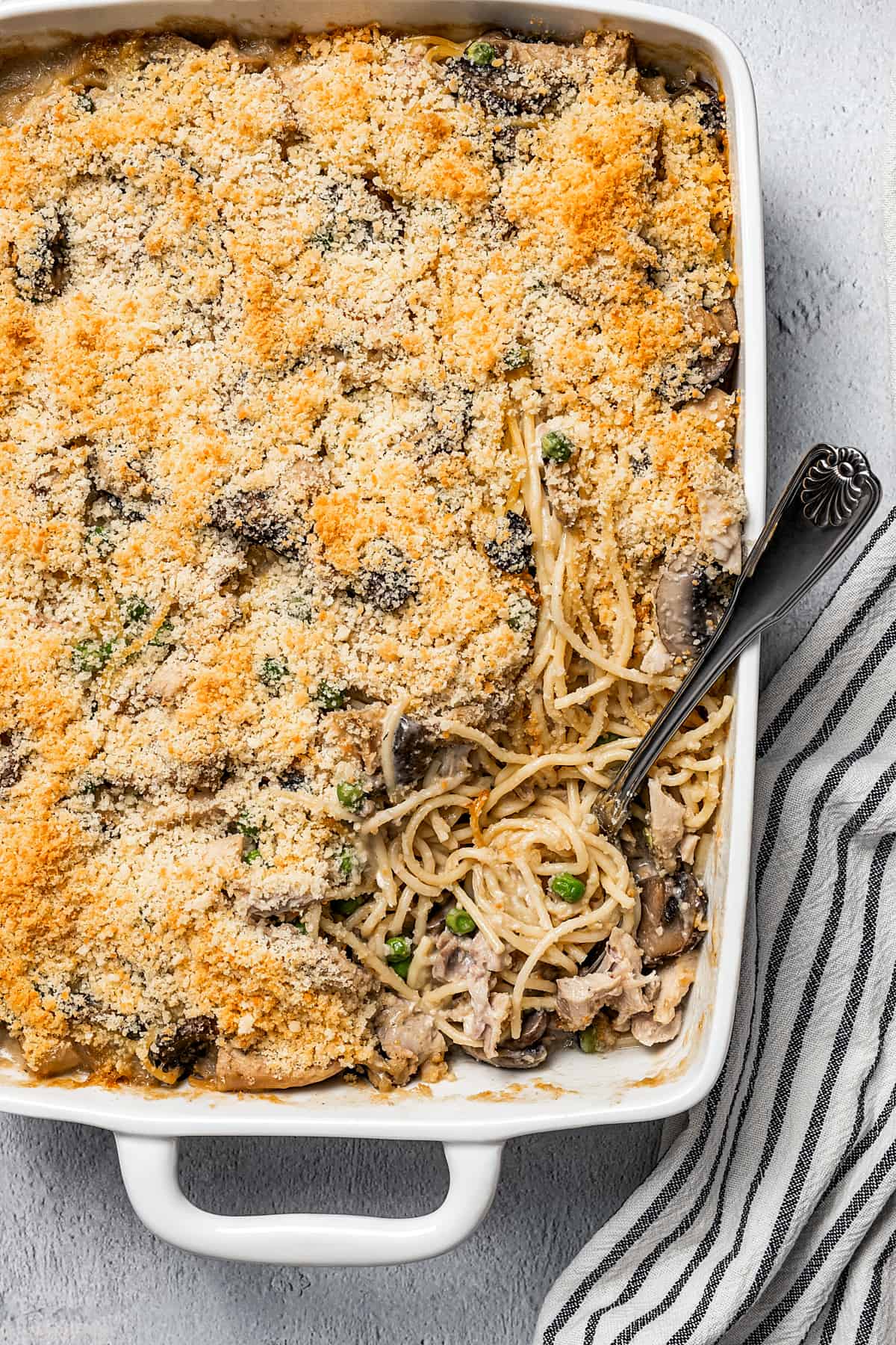 Overhead shot of a turkey pasta bake, with a serving removed from the corner.