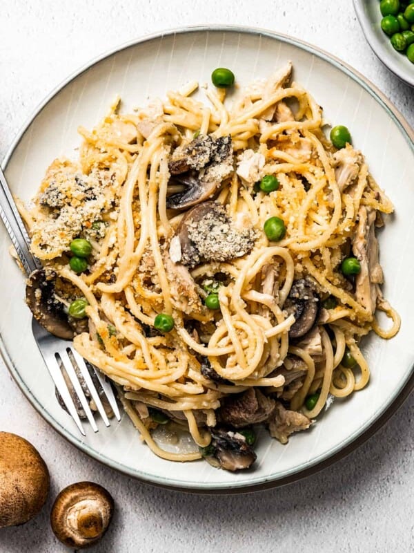 A plate of pasta in creamy mushroom sauce, with leftover turkey.