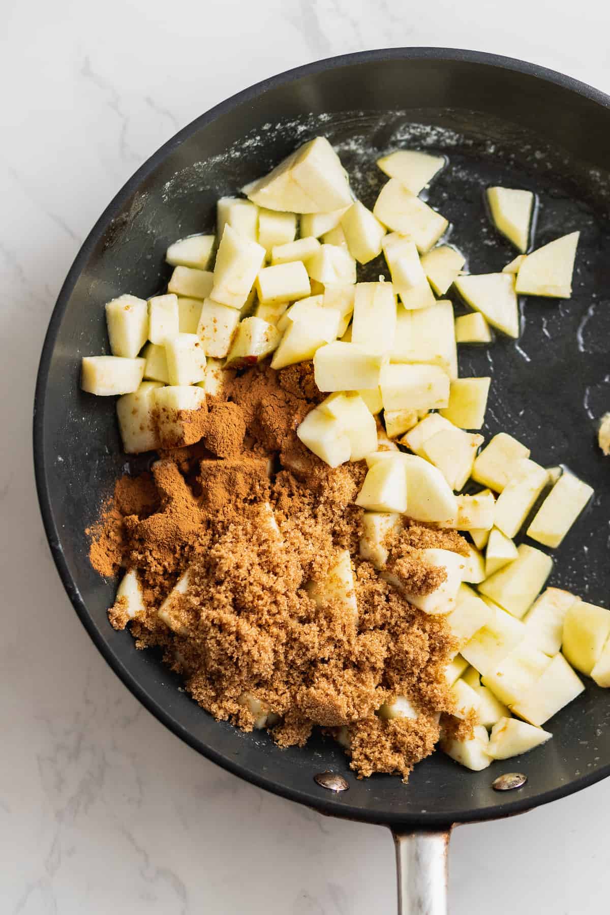 Ingredients for the apple mixture in a pan.