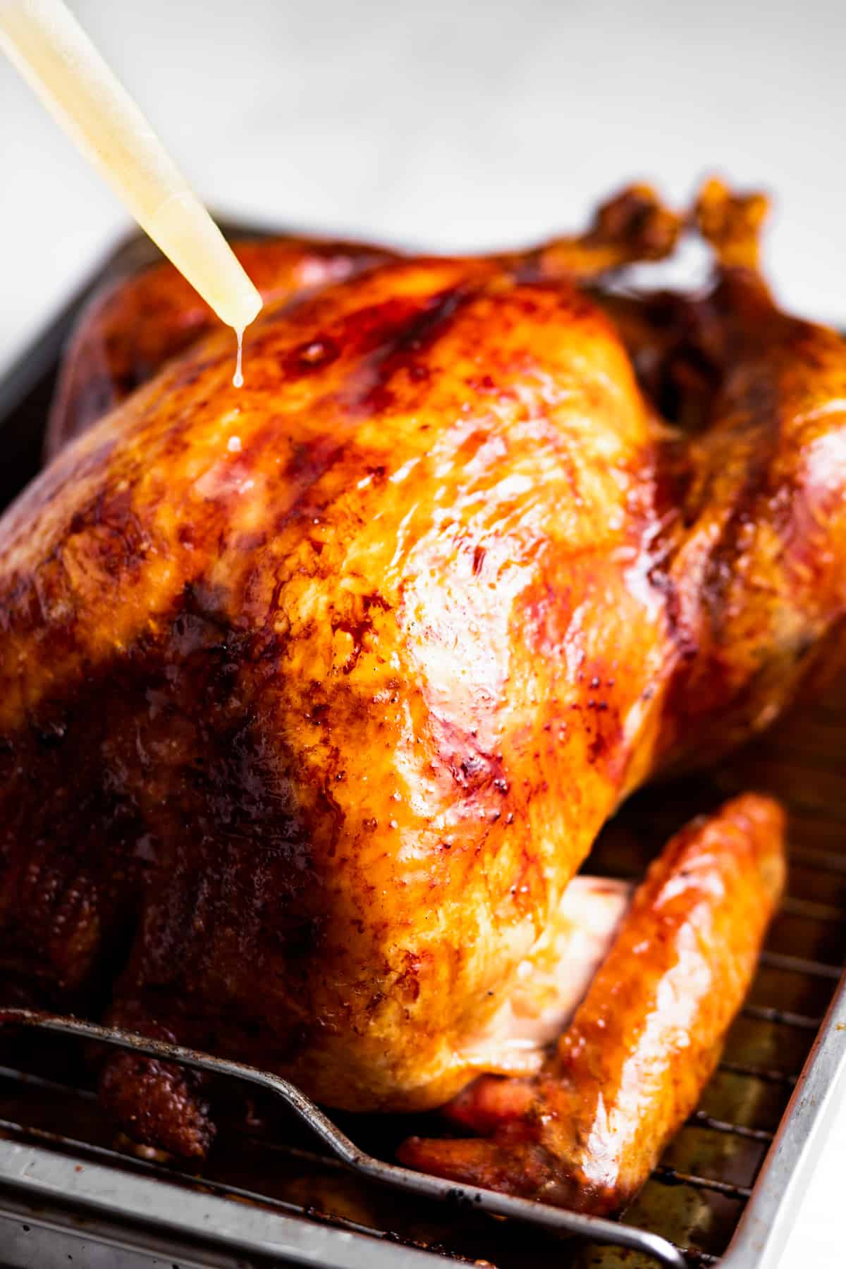 Basting the oven roasted turkey.