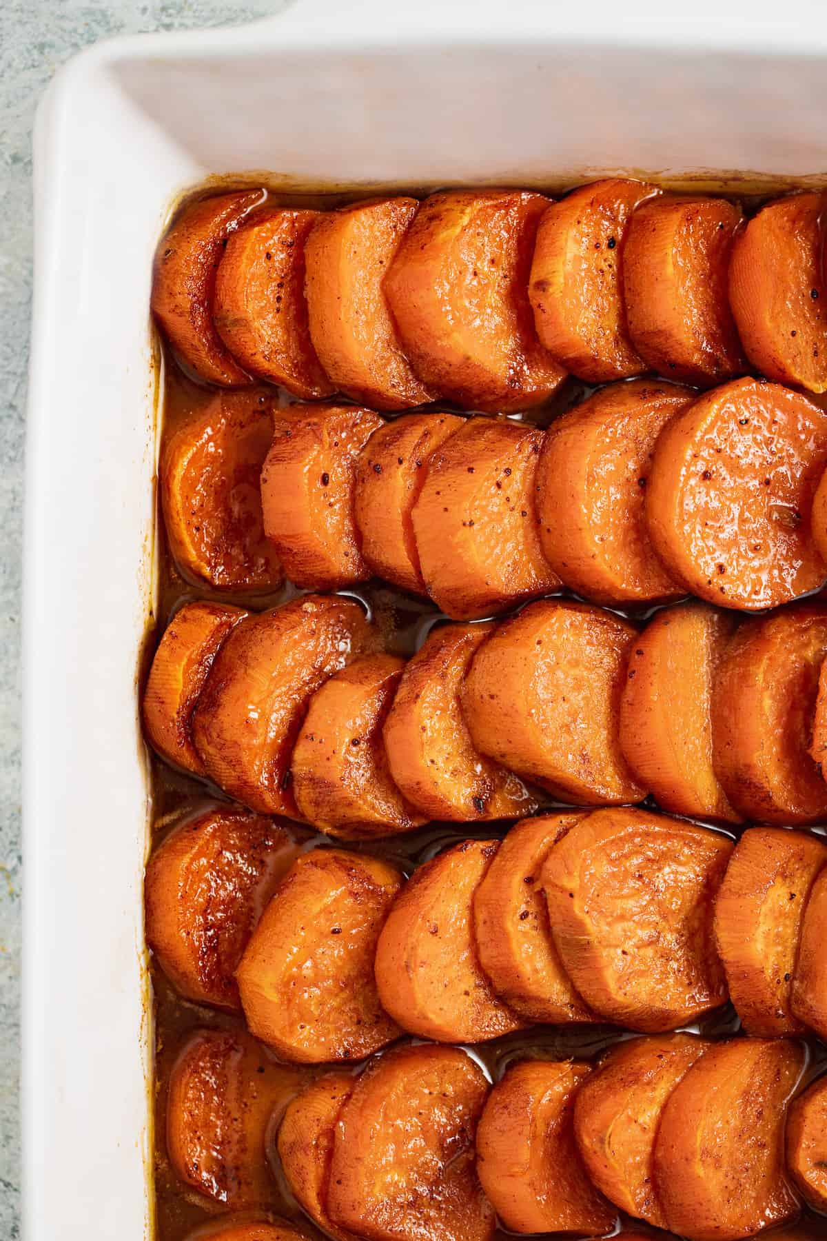Baked candied yams without pecans in the baking dish.